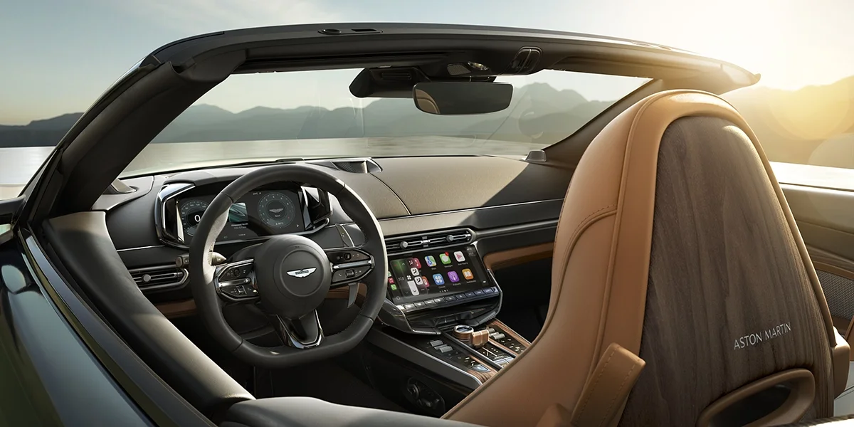 Detailed shot of the “60” embossed logo on tan leather seat headrest in Aston Martin DB12 Volante 60th Anniversary Edition.