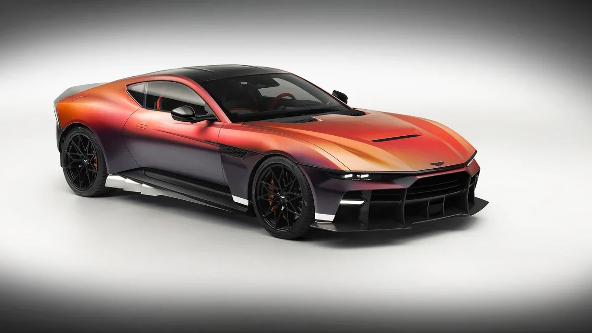 Three-quarter front view of the Aston Martin Valen, highlighting its coachbuilt carbon-fiber body, sculpted hood, and aerodynamic front design.