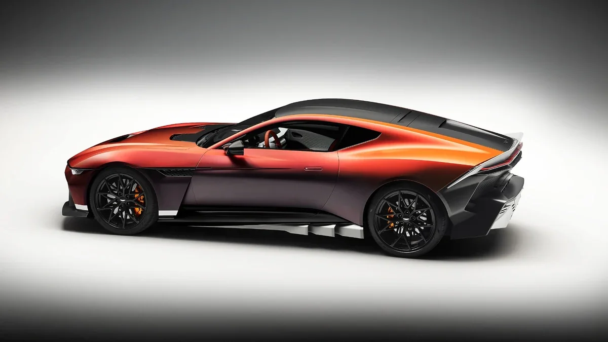Side profile of the Aston Martin Valen showing its elongated front-engined proportions, sculpted bodywork, wheel-arch vents, and aerodynamic rear treatment.