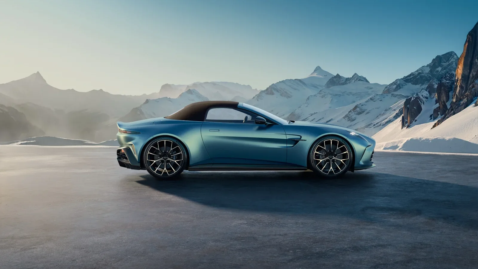 Aston Martin Vantage Roadster side profile in a snowy mountain setting